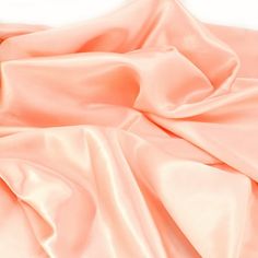 an image of a bed with pink sheets on it