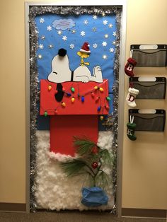 a door decorated to look like snoopy and his christmas tree is on display in the hallway