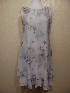 This is a very pretty 2 piece sleeveless long layered dress with matching long sheer chiffon jacket by r&m richards. still in brand new condition. it is a size 8. please go by the measurements below for proper fit. very elegant pretty women look. perfect for a garden party or summer wedding. the dress has a modest scoop neckline with a small keyhole button back. the dress is made of a pastel light sage green floral print crepe chiffon. the flowers are very light pastels of pinks and periwink Summer A-line Dress For Mother Of The Bride, Spring A-line Dress For Mother Of The Bride, Elegant Layered Hem Dress For Garden Party, Elegant Dress With Layered Hem For Garden Party, Spring Evening Dresses With Layered Hem, Fitted Summer Dress With Overlay, Spring Knee-length Dress For Mother Of The Bride, Knee-length Spring Dress For Mother Of The Bride, Summer Flowy Dress For Mother Of The Bride