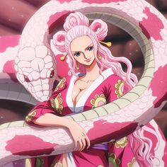 a woman with pink hair is holding a snake