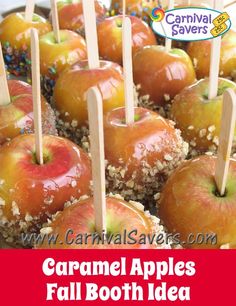 there are many apples with toothpicks in them on the tray and one has sprinkles