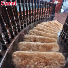 there are many sheepskin rugs on the stair railing and handrails in this photo