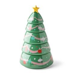 a green ceramic christmas tree with pink ribbon and gold star on top, sitting in front of a white background