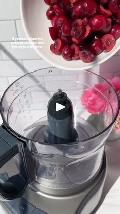 cranberry sauce in a food processor and bowl with cherries next to it