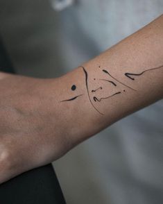 a person's arm with a tattoo on it that has the word love written in cursive writing