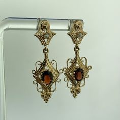 * Vintage 14K Yellow Gold Oval Garnet Seed Pearl Dangle Drop Earrings * Length: 1-7/16" * Width: 1/2" * Oval Garnets measure approximately 6.0 mm x 4.0 mm each * Seed Pearls measure approximately 1.90 mm each * Weight: 4.2 tgw * Marked: 14K * Fastening: Butterfly-NOT INCLUDED * Condition: As pictured. * G3407    Exported By ExportYourStore :) Yellow Gold Oval Filigree Earrings, Oval Yellow Gold Filigree Earrings, Oval Yellow Gold Earrings With Intricate Design, Gold Marquise Pierced Earrings, Gold Oval Earrings With Elegant Design, Elegant Oval Gold Earrings, Victorian Oval Earrings For Anniversary, Victorian Oval Pierced Earrings, Gold Marquise Earrings