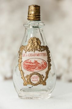 an empty glass bottle sitting on top of a table