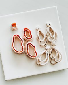 several pairs of scissors sitting on top of a white surface