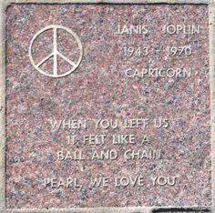 a stone monument with a peace sign on it's face and words written below