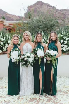 the bridesmaids are all wearing green dresses and holding bouquets in their hands