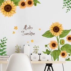 sunflowers are painted on the wall next to a table