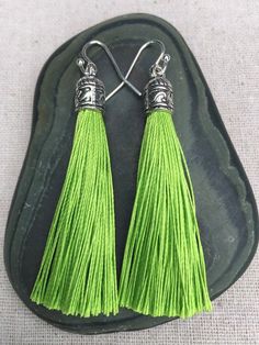 Chic lime green tassel earrings!  They would add a pop of color to any outfit for any occasion.  Dress them up or down.  They are timeless and versatile.  They are lightweight, fun and unique!The tassels measure 2 1/8” long by 1/4” wide.  They hang from simple silver ear wire hooks.  Overall drop length is about 2 1/4”.  Metal is allergy free plated silver.These are my latest creation!  I have them available in many colors!  Find them all under the category tassel earrings in my shop.Thanks for Green Tassel Drop Earrings As Gift, Green Tassel Earrings As Gift, Green Dangle Tassel Earrings For Summer, Elegant Green Tassel Earrings For Summer, Green Fringe Earrings For Summer, Green Tassel Jewelry For Summer, Green Dangle Tassel Earrings For Pierced Ears, Formal Lime Green Gemstone Jewelry, Green Beaded Tassel Drop Earrings