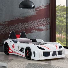 a white and red sports car bed in a room