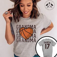 "Show your love and support for your basketball superstar with this Customized Basketball Grandma T-Shirt! Designed with comfort and style in mind, this shirt features a classic basketball design with a heartwarming twist. Customize it with your grandchild's name and number on the back to make it uniquely yours. Whether you're cheering from the stands or running errands, this shirt is perfect for any occasion. Available in various sizes to ensure the perfect fit. Order one today and wear your pride on your sleeve - or rather, on your chest! It makes a great gift too. Our t-shirts are soft and comfortable. Please make sure to check our size chart and choose accordingly. We're happy to help if you have any questions! How to Order  1.View color and size charts before you place your order. 2.S Basketball Team Spirit Short Sleeve Tops, Basketball Fan Apparel Tops With Sublimation Print, Sublimation Print Tops For Basketball Fans, Basketball Crew Neck T-shirt With Letter Print, Basketball T-shirt With Letter Print And Crew Neck, Fan Apparel Tops With Sublimation Print For Basketball, Sporty Basketball T-shirt With Letter Print, Basketball Team Name T-shirt For Sports Season, Graphic Tee T-shirt With Team Name For Basketball