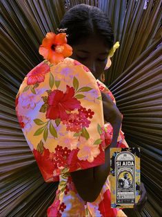 a woman in a kimono with flowers on her head and an ad for st aid