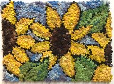 a close up of a rug with yellow flowers on it and green leaves in the middle