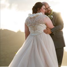 the bride and groom are embracing each other