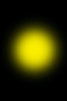 a black background with yellow light in the center and dark space at the bottom that appears to be very bright