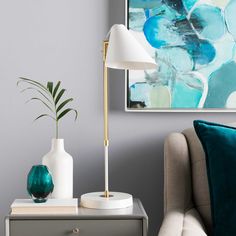 a living room scene with focus on the floor lamp and side table in front of the couch