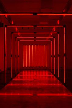 an empty room with red lights in it