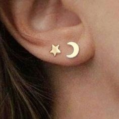 a woman's ear with a small gold star and moon stud on the side