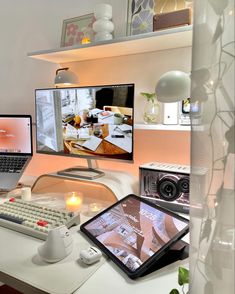 a laptop computer sitting on top of a white desk