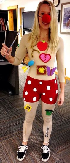 a woman dressed as a clown holding a pair of scissors