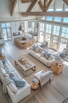 a living room filled with furniture and large windows