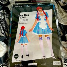 Racy Rag Doll Costume Includes: Polka Dot Dress With Attached Apron And Collar Bring Your Childhood To Life In This Racy Rag Doll Costume Featuring A Blue Dress With Lightly Puffed Sleeves, A Sweetheart Neckline With A Ruffled Trim, White Button Accents, A White Apron Detailing With A Blue Ribbon Trim, An Allover Pink Polka Dot Design, A White Hem, And A White Collar With Blue Button Accents. (Wig And Thigh-High Stockings Not Included.) Police Officer Halloween Costume, Rag Doll Costume, Cowgirl Halloween Costume, Captain Costume, Nun Costume, Cowgirl Halloween, Bodysuit Costume, White Apron, Bunny Costume