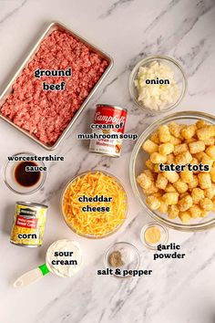 ingredients to make tater tots laid out on a white marble counter top, including ground beef and cheese