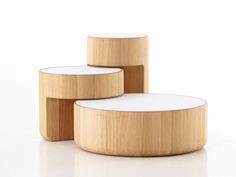 three wooden tables sitting next to each other