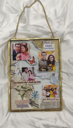 a gold frame hanging on a white sheet with pictures and words attached to the wall