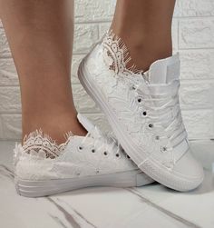 a woman's feet with white lace on them