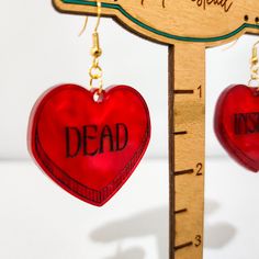 🖤 Express your unique style with our Heart Shaped Acrylic Earrings featuring a bold "Dead Inside" statement. These quirky and edgy earrings are perfect for anyone with a dark sense of humor or a certain aesthetic. Each heart-shaped earring carries its own word: "dead" on one and "inside" on the other, making a bold statement that's sure to stand out. Perfect for concerts, parties, or as a daily accessory to add a touch of personality to any outfit. Edgy Red Earrings As Gift, Edgy Red Earrings For Gift, Edgy Red Earrings For Gifts, Punk Heart-shaped Earrings For Gifts, Punk Heart Earrings As A Gift, Punk Style Heart-shaped Earrings As Gift, Punk Style Heart Shaped Earrings For Gift, Punk Style Heart Earrings For Gift, Dark Sense Of Humor