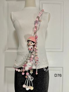 a mannequin is adorned with pink and white beads on it's neck