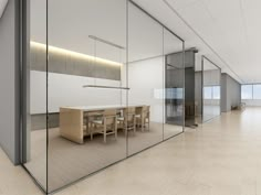 an empty conference room with glass walls and wooden tables