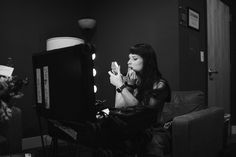 a woman sitting in front of a computer screen