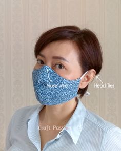 a woman wearing a blue face mask with words on it