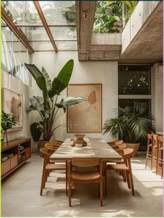 a dining room table surrounded by plants and potted trees in the background is an open floor plan