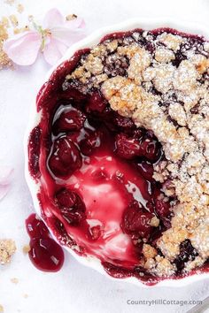 a pie with crumbs and cherries in it