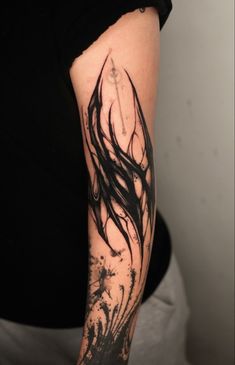 a woman's arm with black ink on it