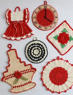 crocheted christmas ornaments are arranged on a white surface with red and black accents