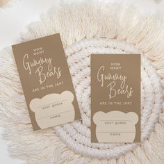 two brown and white bookmarks sitting on top of a blanket