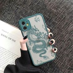 a person holding an iphone case with a green dragon on the front and blue back