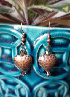 These boho-style earrings are made of copper colored metal and glass beads. They look great with denim! Bohemian Festival Earrings With Heart Beads, Bohemian Earrings With Heart Beads For Festivals, Bohemian Heart Beads Earrings For Festival, Bohemian Nickel Free Heart Earrings, Nickel-free Bronze Beaded Copper Earrings, Bronze Copper Beaded Earrings As Gift, Copper Heart, Boho Style Earrings, Boho Stil