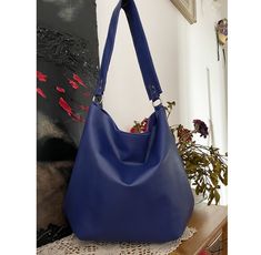 This Purse Bag Leather is meticulously crafted from high-quality calf leather in a stunning blue hue. Calf leather is renowned for its softness, durability, and natural beauty, making it a perfect choice for a sophisticated accessory. The Blue Leather Handbag showcases a timeless and elegant design, suitable for various occasions. Its silhouette adds a touch of sophistication to any outfit, while the vibrant blue color brings a pop of color to your ensemble. To provide convenient access and secu Elegant Blue Smooth Grain Bags, Luxury Blue Smooth Grain Bag, Luxury Blue Bags With Smooth Grain, Modern Blue Smooth Grain Shoulder Bag, Modern Blue Shoulder Bag With Smooth Grain, Modern Blue Bags With Smooth Grain, Modern Blue Bag With Smooth Grain, Modern Blue Soft Leather Hobo Bag, Blue Soft Leather Shoulder Bag For Travel