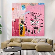 a living room filled with furniture and a large painting on the wall above it's couch