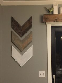 three wooden chevrons hang on the wall