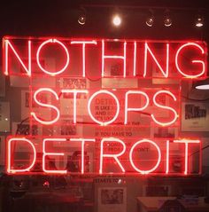 a neon sign that says nothing stops detroit