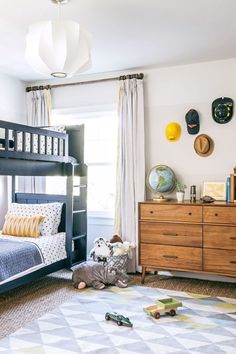 a child's bedroom with bunk beds, dressers and toys on the floor